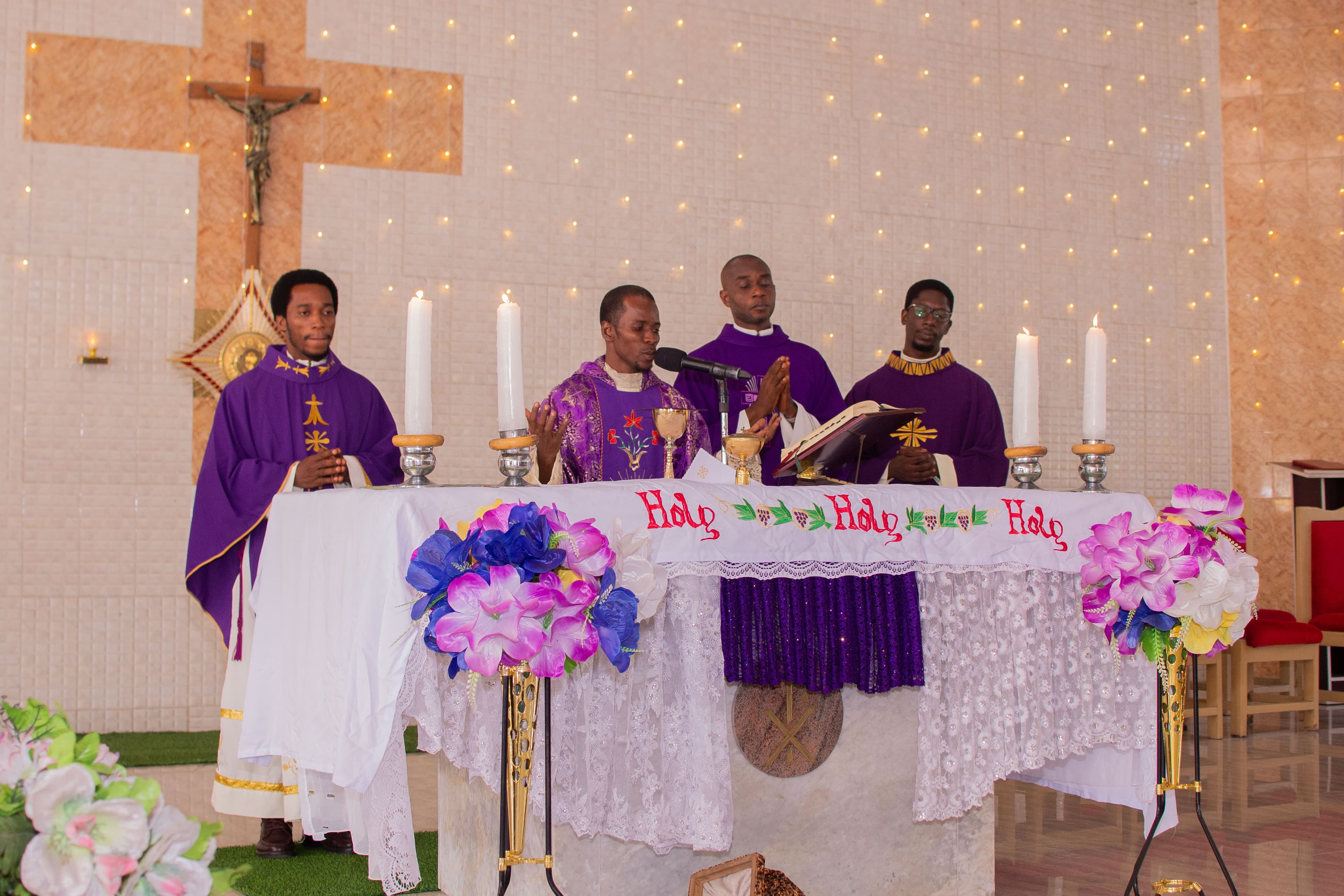 Priests consecrating the Eucharist